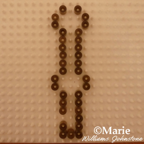 Working fused beads Perler pattern on white peg board