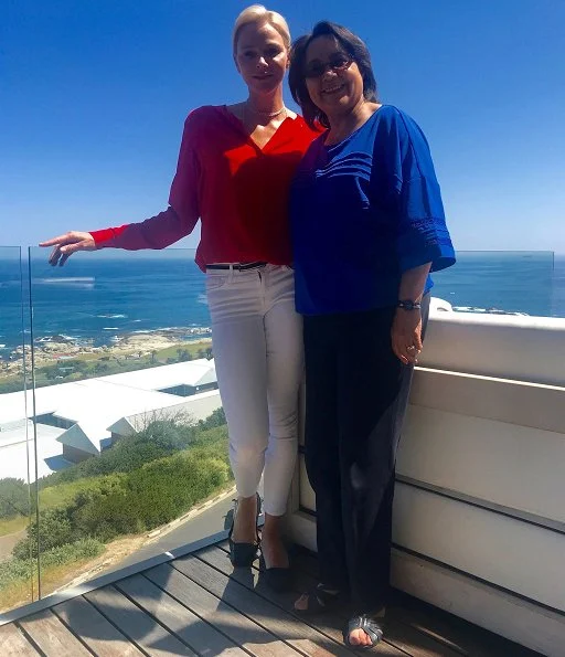 Princess Charlene met with Cape Town Mayor Patricia de Lille. Princess Charlene of Monaco Foundation. Princess Charlene wore red blouse