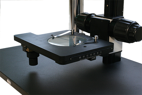 Common main objective stereo microscope dual observer system with custom mechanical stage.
