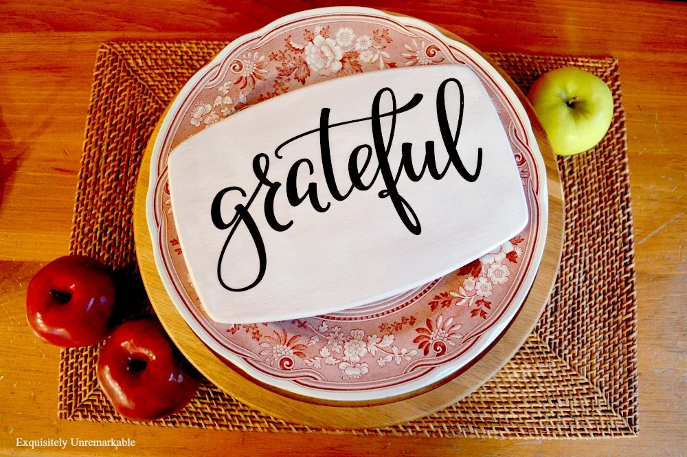 Wooden Grateful Sign For Fall on a plate and one a placemat with applies around it