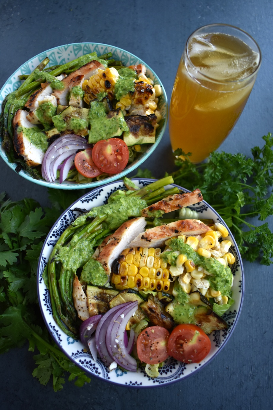 Chicken Chimichurri Salad is loaded with grilled chicken, corn, asparagus, zucchini, red onion and tomatoes and topped with a fresh parsley and cilantro herb chimichurri vinaigrette. www.nutritionistreviews.com