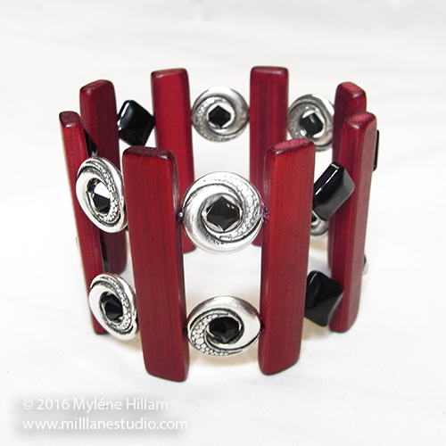Red bamboo bead bracelet with silver spacers and black beads