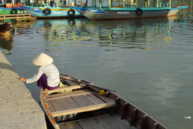 Old Women make a living by rowing boats at Hoi An
