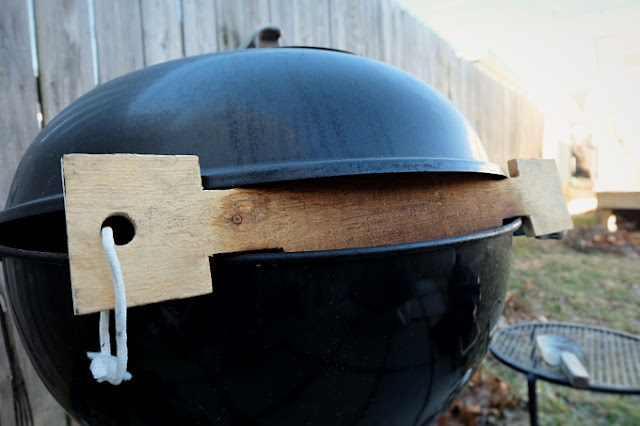 grill lid propped open with pallet wood