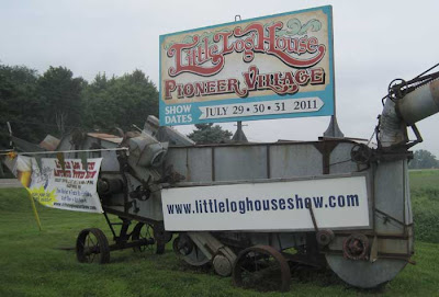 Little Log House sign on an antique harvesting machine