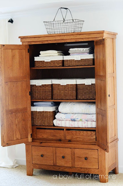 Use baskets for organizing an armoire into a closet:: OrganizingMadeFun.com