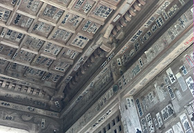 Senjafuda (name tags) pasted on the walls and ceiling of a temple gate.