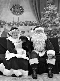 doberman mix puppy with Santa and Mrs Claus