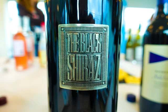 A close up of a metallic label saying The Black Shiraz from Berton Vineyards