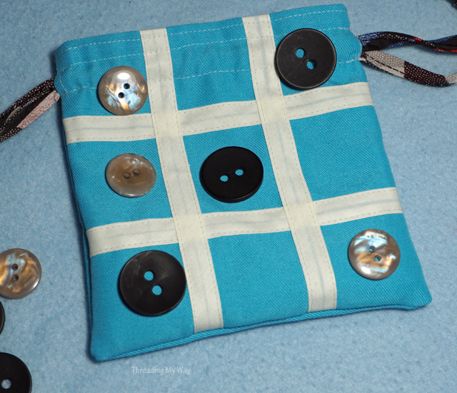 Make a travel tic tac toe game with a simple drawstring bag. Also known as naughts and crosses. Threading My Way