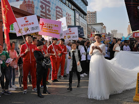 young woman wearing a bridal gown and using a mobile phone in Mudanjiang, China