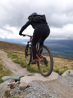 woman jumping on mountain bike