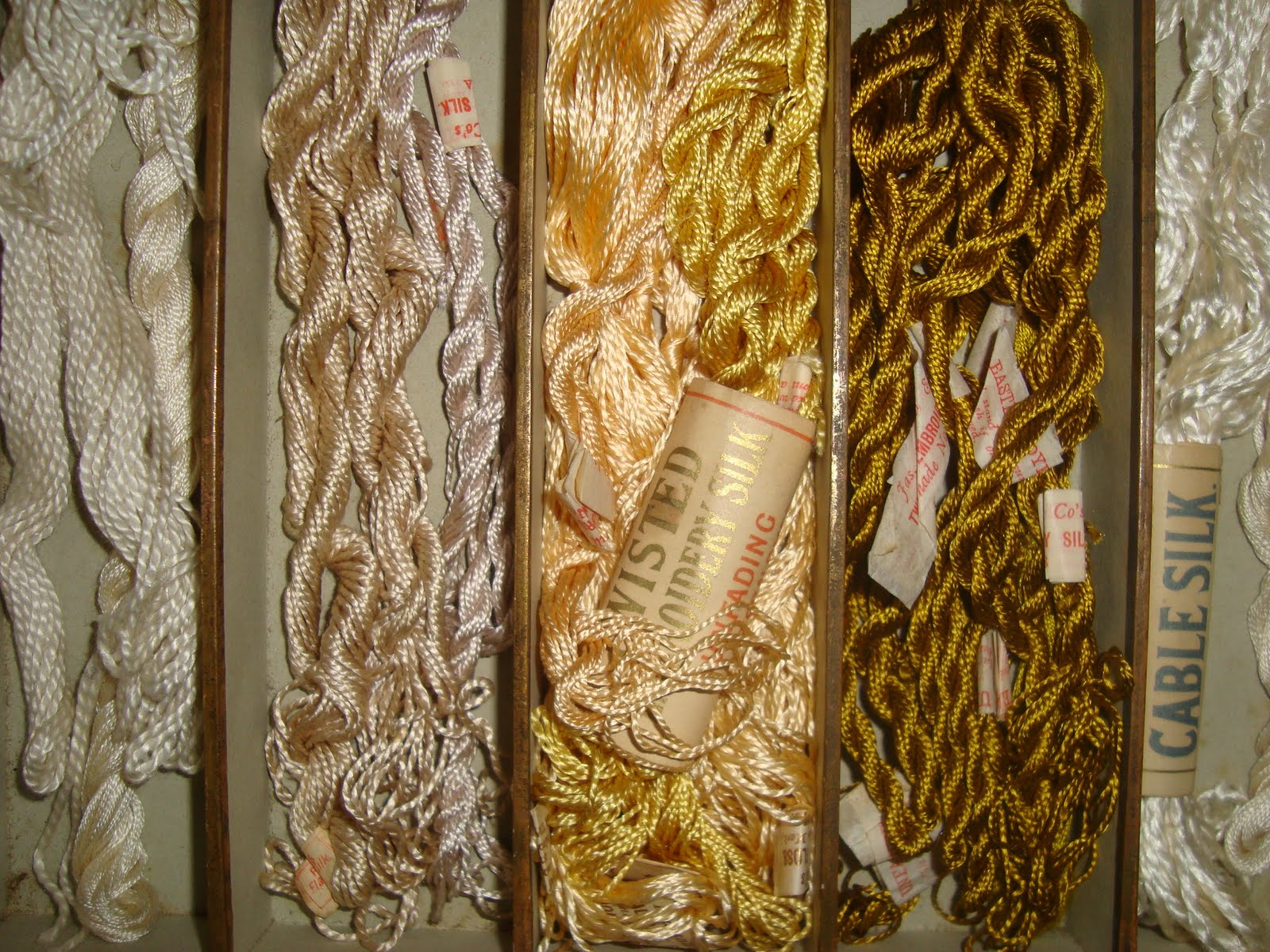 Interesting Antique Textiles A vintage shop display box of embroidery