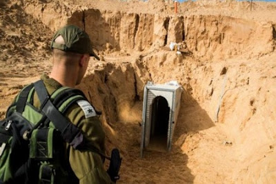 An Israeli army officer walking near the entrance of a tunnel leading from the Palestinian enclave