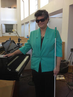 Laurel standing by grand piano