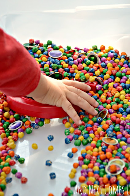 Exploring magnets with preschoolers in a rainbow chickpeas sensory bin