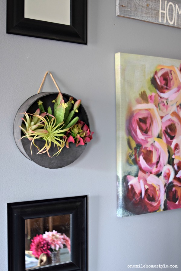 Pretty pink farmhouse spring home tour with an updated pink and black gallery wall with hanging faux succulent details.