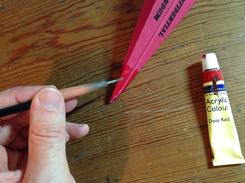 Painting the nose red Applying red acrylic to the nose of the plane