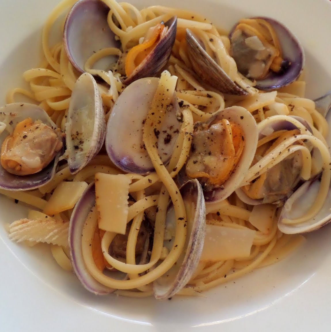 Clam Linguine:  Clams cooked in white wine sauce then tossed with linguine.  A delicious dinner that may look fancy but is really quite simple.