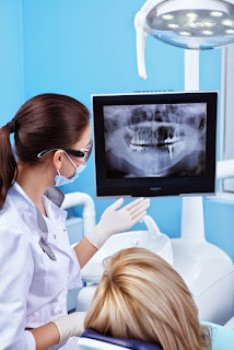 A doctor showing dental x-ray to a patient