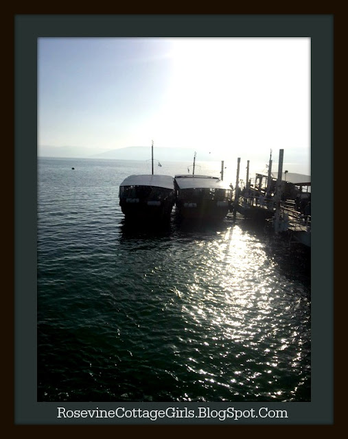 Boats on the Sea of Galilee with the sun shining on the water