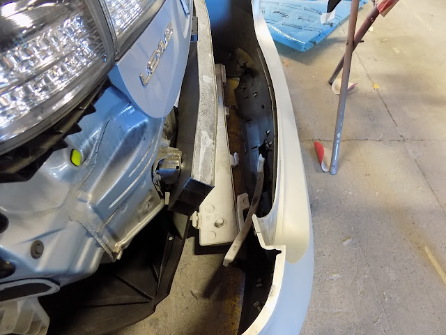 Damaged parts inside bumper cover on Lexus HS250h prior to repairs at Almost Everything Auto Body.