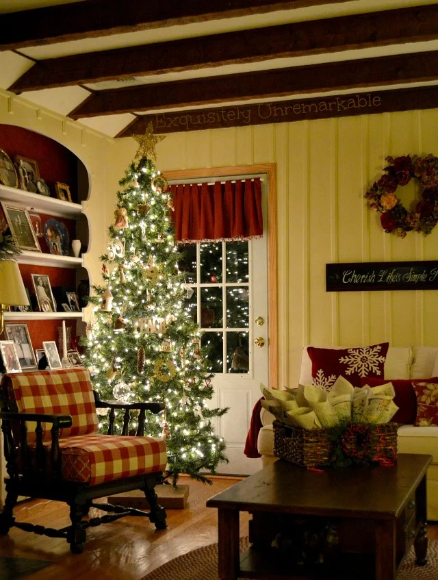 Rustic Christmas Living Room with lit tree at night and buffalo check chair
