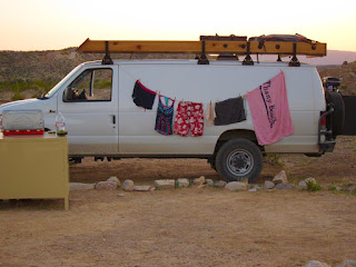 Clothesline stretches from front to back of camper van to dry swimsuits.