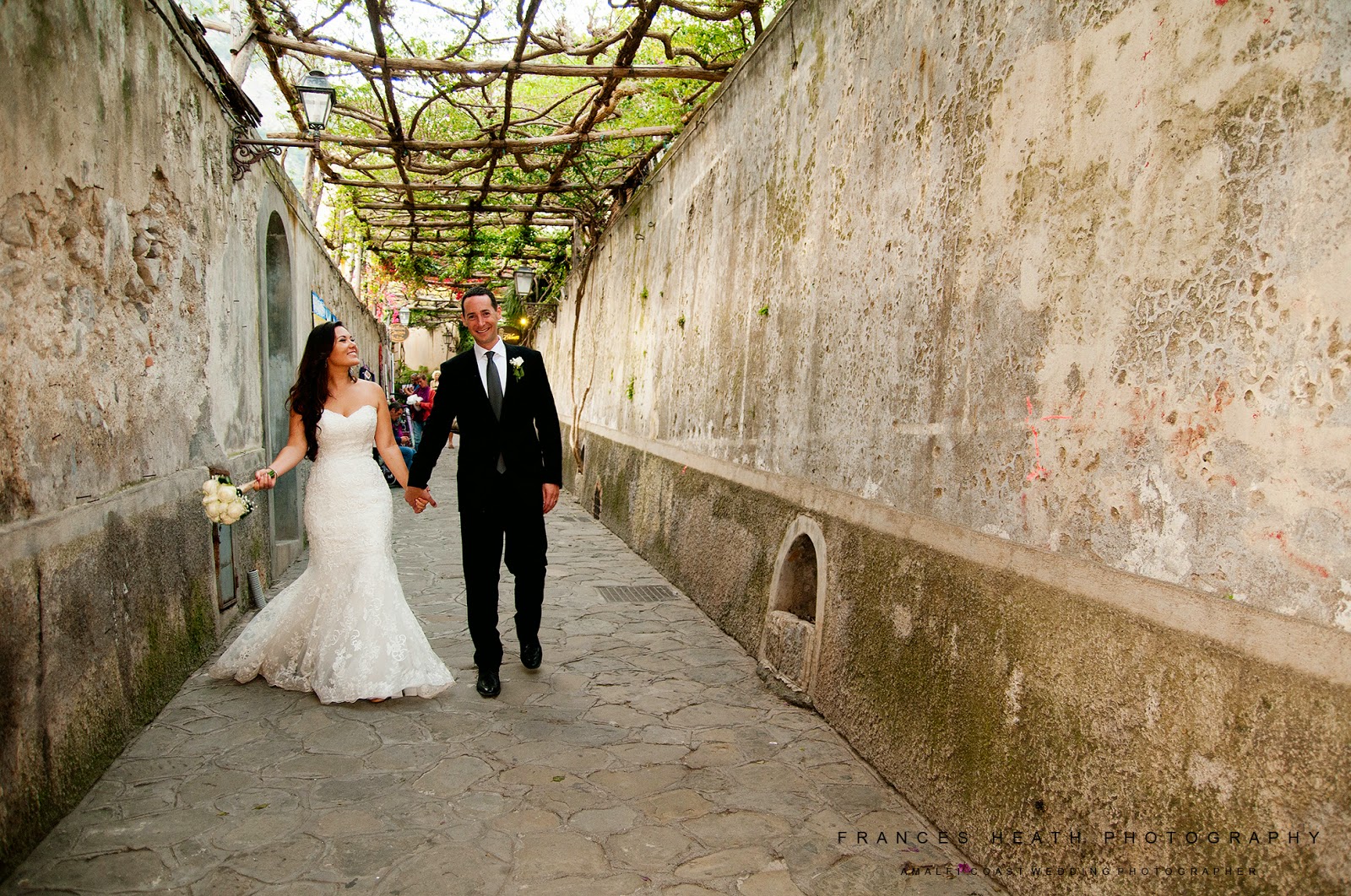 Bride and groom walking in Positano