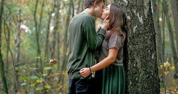 Kiss hug romantic charming couple in forest tree