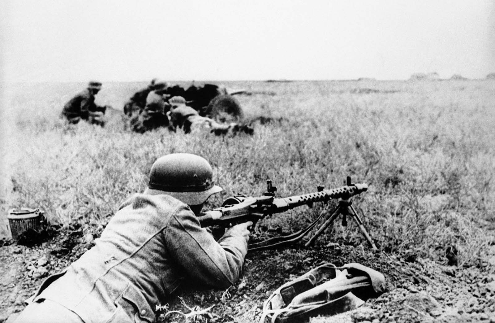 The bare landscape of Crimea, Ukraine, offers little protection in warfare, and German infantrymen hug the ground to escape enemy fire, on January 7, 1942.