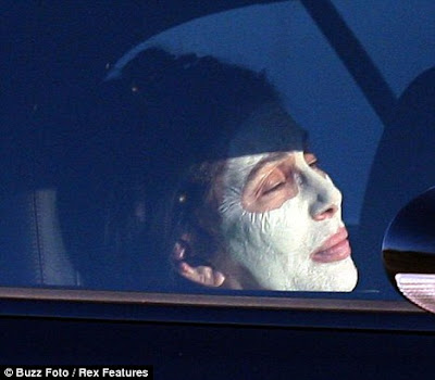 Cher sporting a white face mask