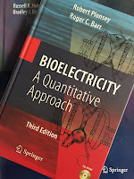 Bioelectricity: A Quantitative Approach, by Robert Plonsey and Roger Barr, superimposed on Intermediate Physics for Medicine and Biology.