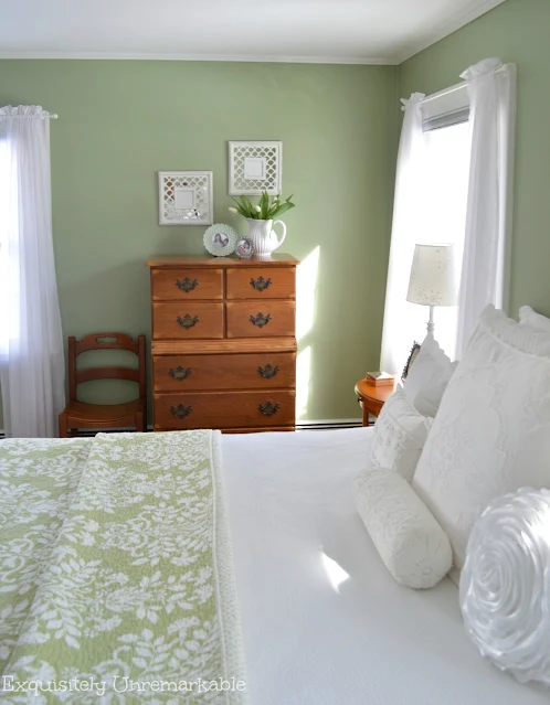 Cottage Style Bedroom with green walls and green quilted bedding