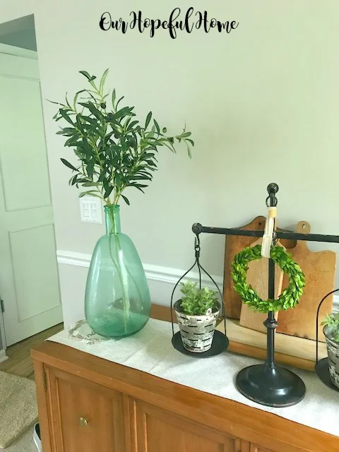 farmhouse dining room demijohn olive branches balance scale olive bucket cutting boards boxwood wreaths