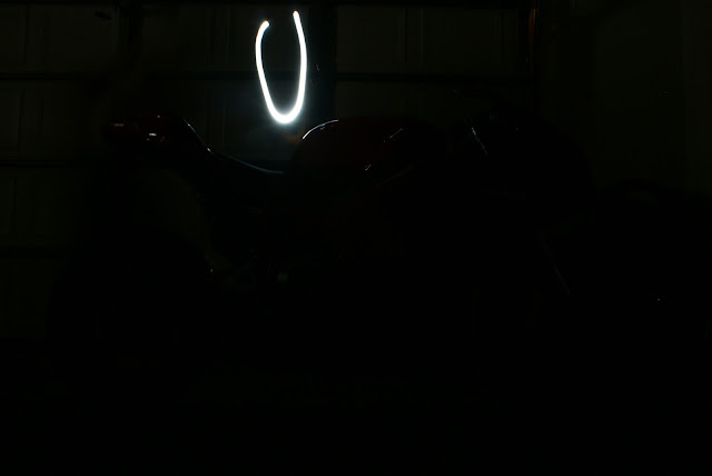 Standing behind the bike with a flashlight