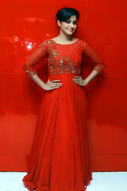 HEROINE REMYA NAMBEESAN IN LONG RED DRESS AND STANDING A RED BACKGROUND VIEW IMAGES Navel Queens HEROINE REMYA NAMBEESAN IN LONG RED DRESS AND STANDING A RED BACKGROUND VIEW IMAGES Navel Queens