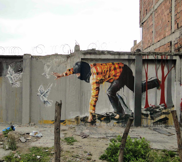 Australian Street Artist Fintan Magee paints a new mural entitled "Bad Hunter" on the streets of Bogota in Colombia. 1