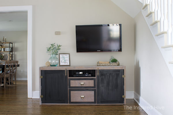 Dresser makeover. How I turned an old dresser into a modern farmhouse style entertainment center. This TV stand has weathered wood, black paint, and antique brass hardware.