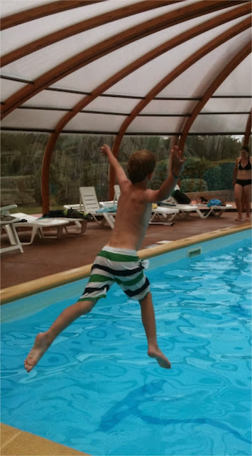Child jumping into swimming pool