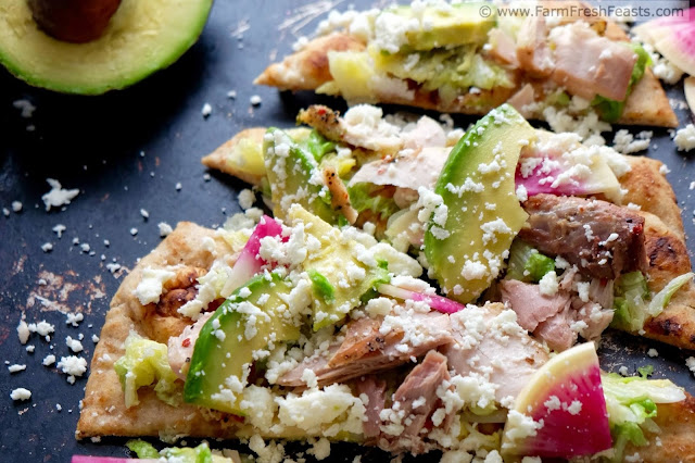 A fast and easy fresh tasting pizza this simple naan crust is topped with mahi mahi, sautéed Napa cabbage, avocados, watermelon radishes, and crumbled queso.