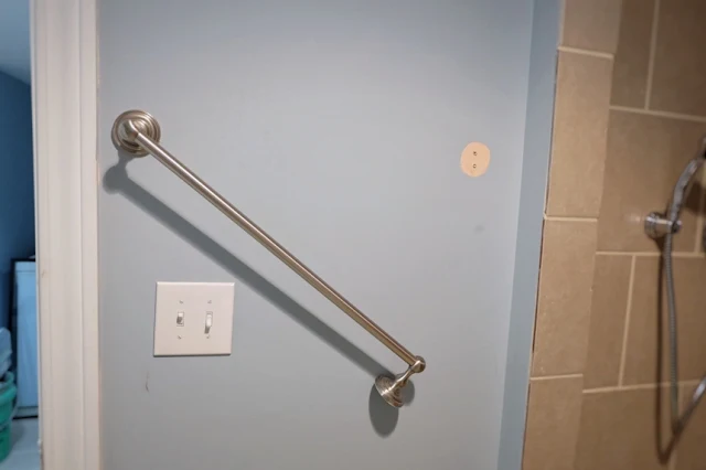 broken towel bar in basement bath