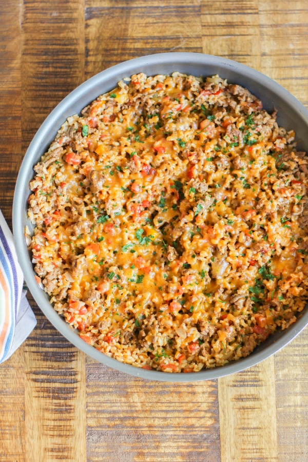 This One Pan Taco Rice Skillet is easy to make and is filled with veggies and beef, making it the perfect protein packed meal to feed your family on any busy night!