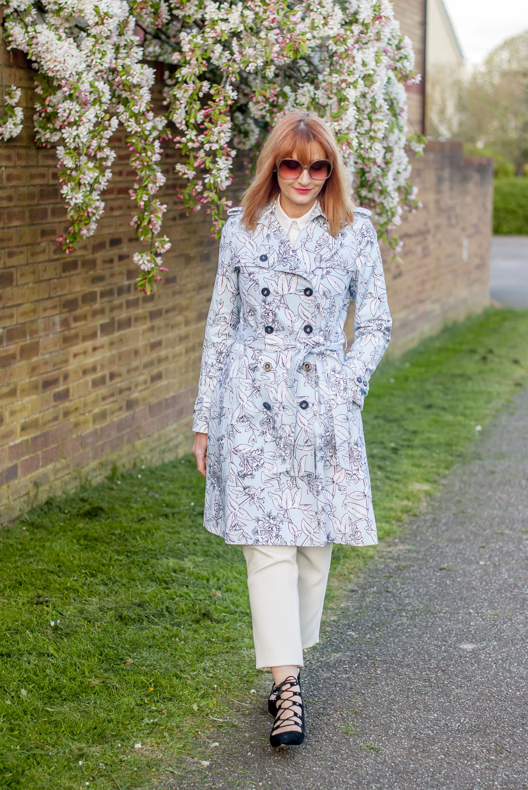 Spring fashion: Blue floral trench coat white trousers black lace-up ghillie shoes oversized 70s sunglasses | Not Dressed As Lamb, over 40 style
