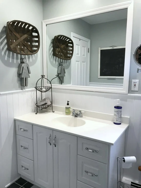 Framed mirror and white vanity in bathroom