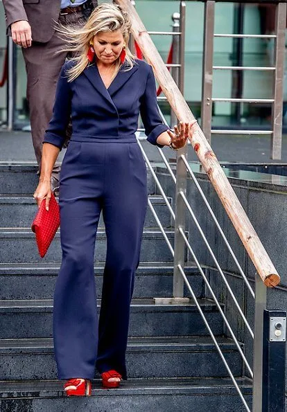 Queen Maxima wore Natan crepe jumpsuit. Queen Maxima's outfit is by Belgian fashion house Natan. red sandals and clutch