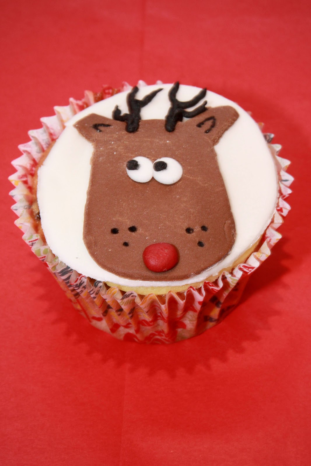 Rudolf cupcake, Rudolf the red-nosed reindeer, Christmas, winter, seasonal, cake topper Christmas cupcake topped with a fondant Rudolf the reindeer head picture