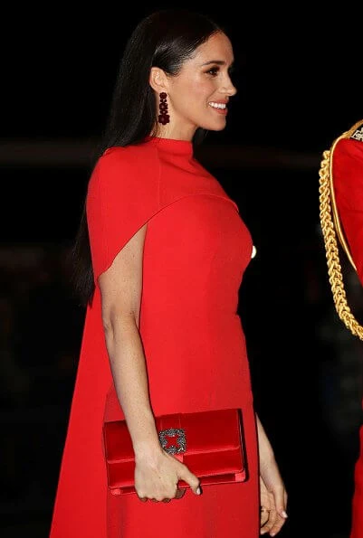 Meghan Markle wore Safiyaa Kalika dress, Stuart Weitzman Nouveau pumps, Simone Rocha earrings, Manolo Blahnik clutch bag