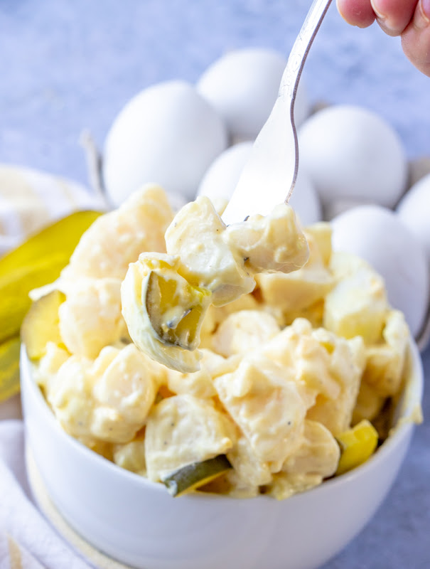 Dill Pickle Potato Salad! Sure to be a new family favorite! The tangy flavor of the dill pickles adds a delicious pop of flavor to this salad! Make it for your next picnic or BBQ!