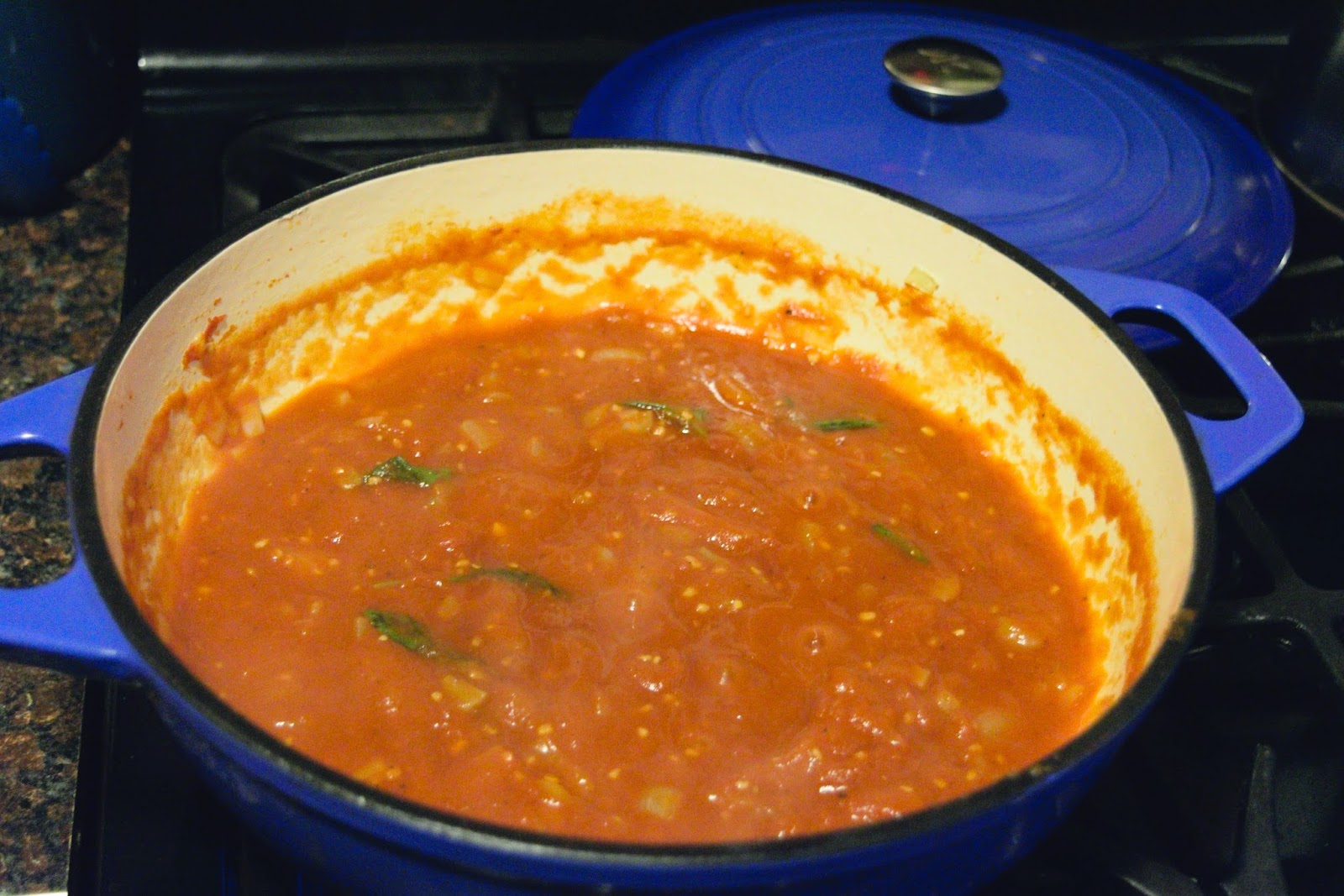 The marinara simmering in the sauce pot. 
